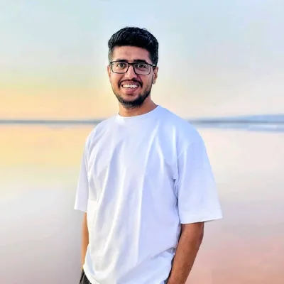 Shubham Goel at the beach, smiling